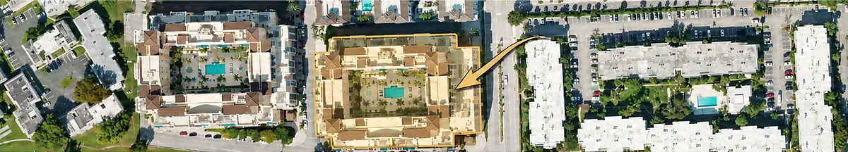 Aerial view of The Colonnade at Dadeland, outlined in gold with an arrow, among the neighboring blocks.